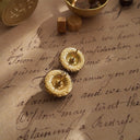 The reverse side, showing the signature scrollwork texture of 1928 Jewelry, as well as a spot of discoloration, defining its authentically aged character.