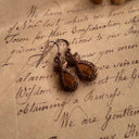 The reverse side, showing the signature scrollwork texture of 1928 Jewelry, as well as visible discoloration, defining its authentic "Wabi-Sabi" character.