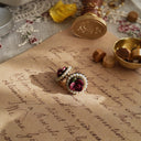 An angled view of the pink floral earrings, highlighting the handcrafted feel of the sculpted clay rose petals and the soft, matte finish of the antiqued gold setting