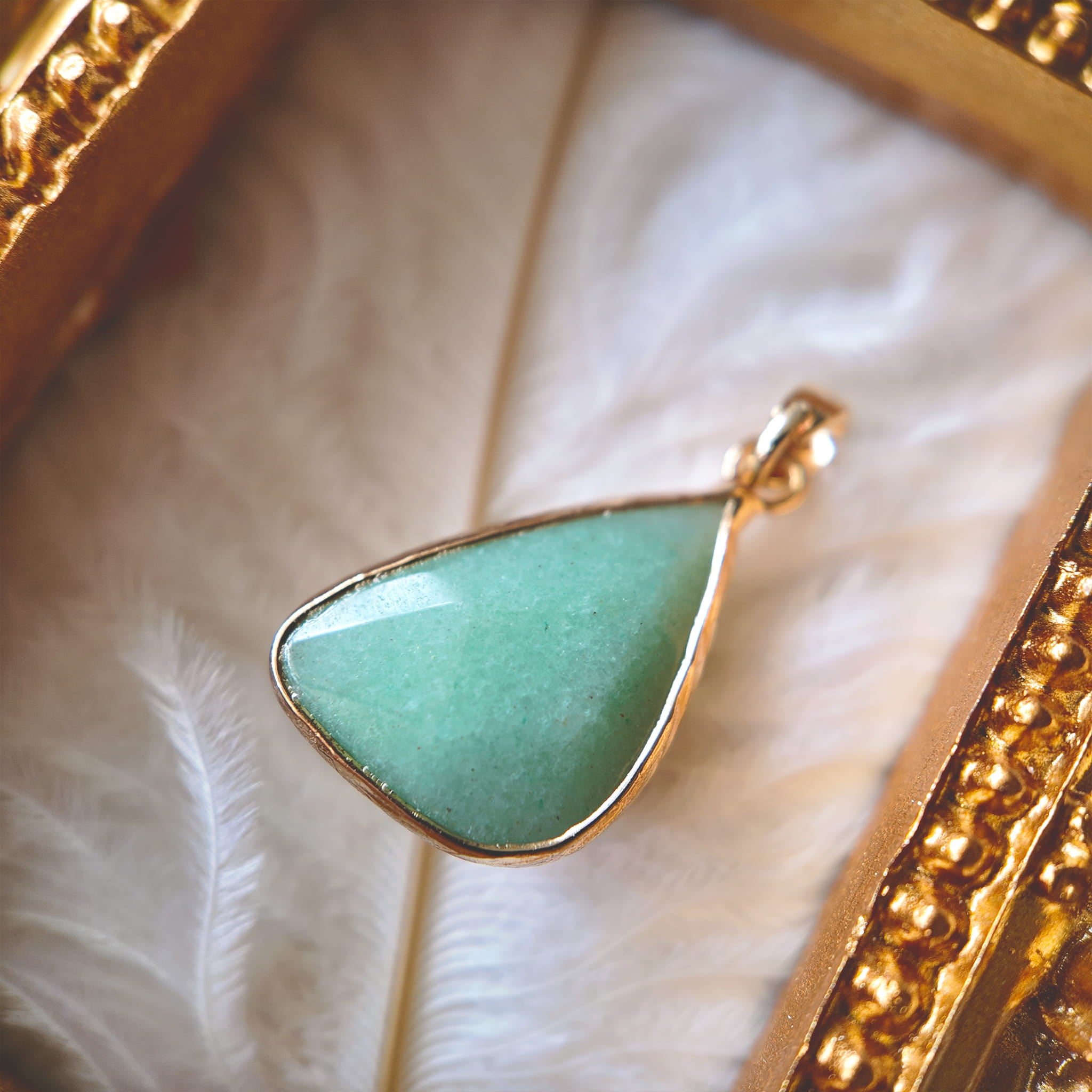 A macro shot detailing the soft, pale mint/seafoam green hue and the subtle, characteristic shimmer of the Natural Green Aventurine stone.