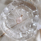 The reverse side of the upcycled White Quartz charm, showcasing the beautiful, natural internal fractures and mists visible through the stone.