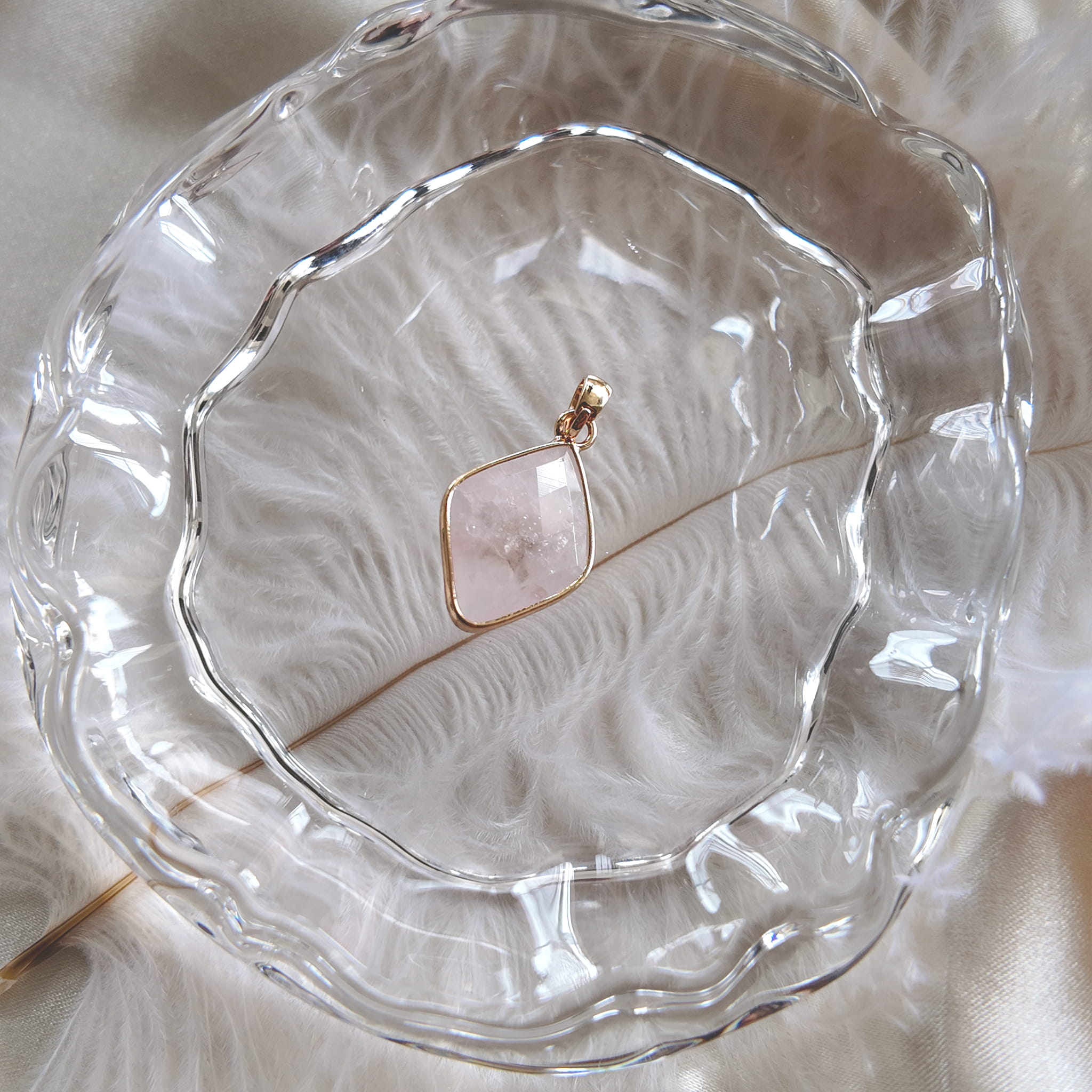 The reverse side of the upcycled White Quartz charm, showcasing the beautiful, natural internal fractures and mists visible through the stone.