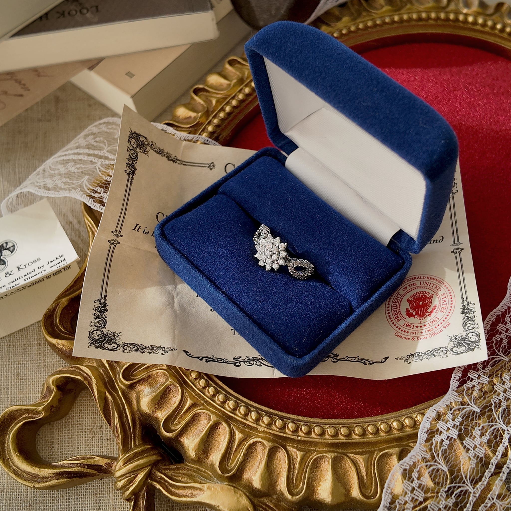 The silver ring features glass diamonds set in a floral pattern; this is a collaboration between Camrose & Kross and JBK, and comes with its original box and authentication card.