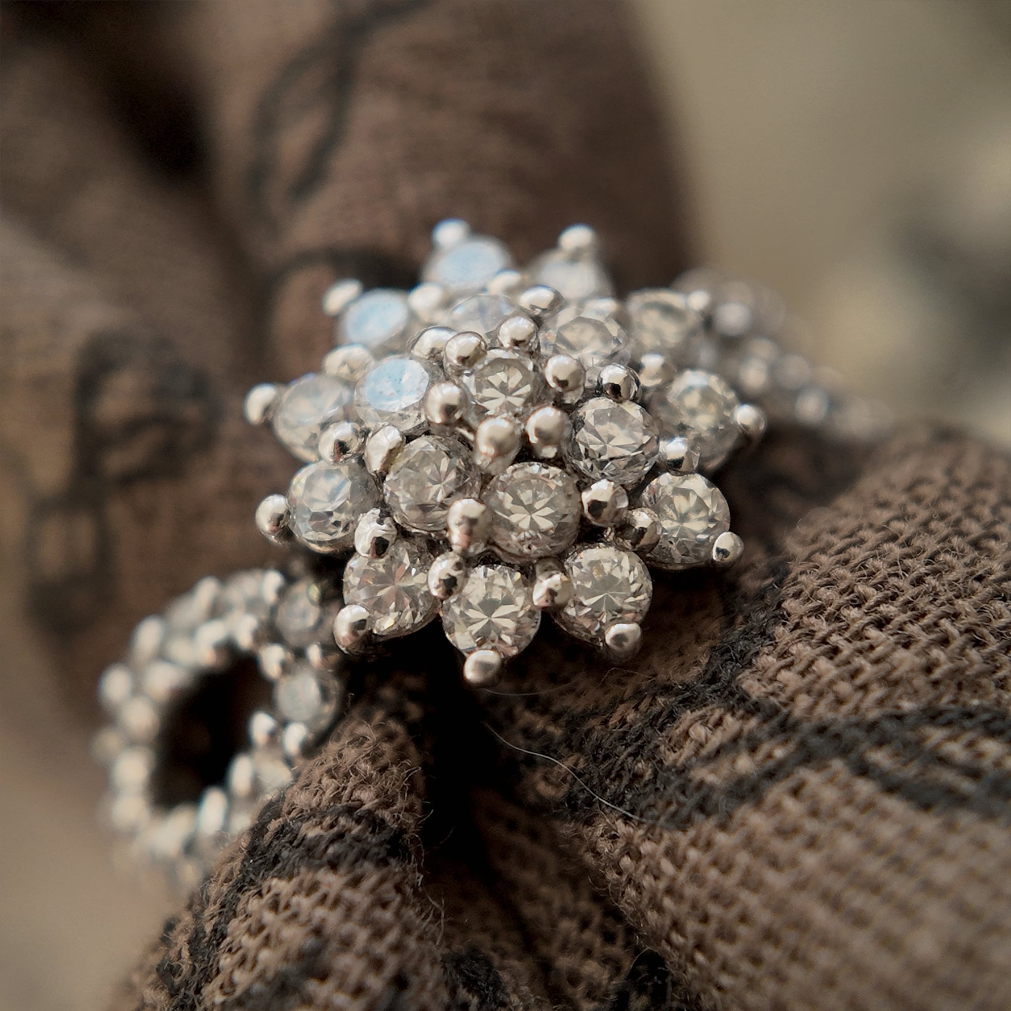 Under high magnification, the quality of rhinestone is revealed: clean, multi-faceted cuts, and a shine as if brand new.