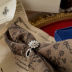 Images of a ring worn on a hand, showcasing the details of the rhinestone, its clean cut, and top-notch craftsmanship.