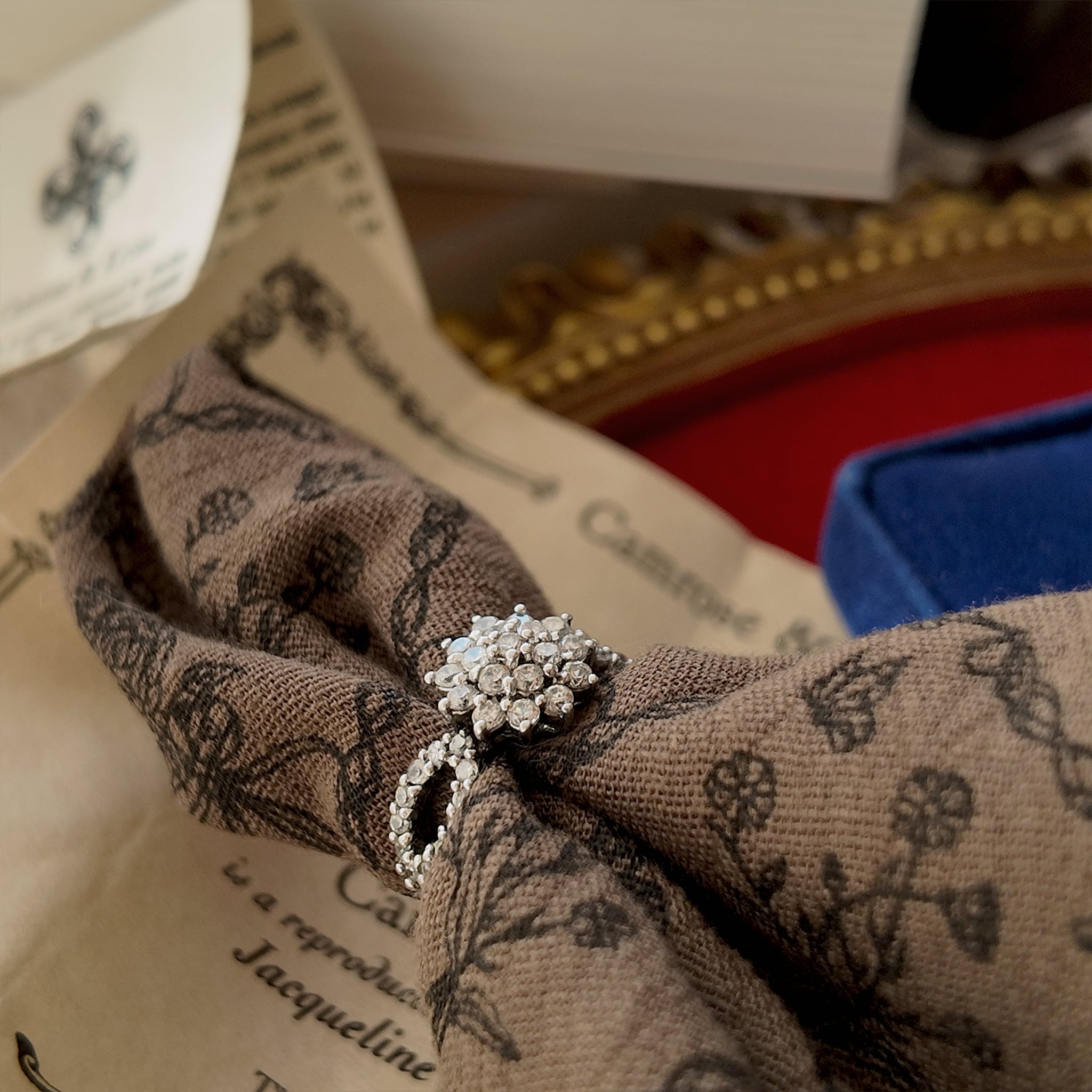 Images of a ring worn on a hand, showcasing the details of the rhinestone, its clean cut, and top-notch craftsmanship.