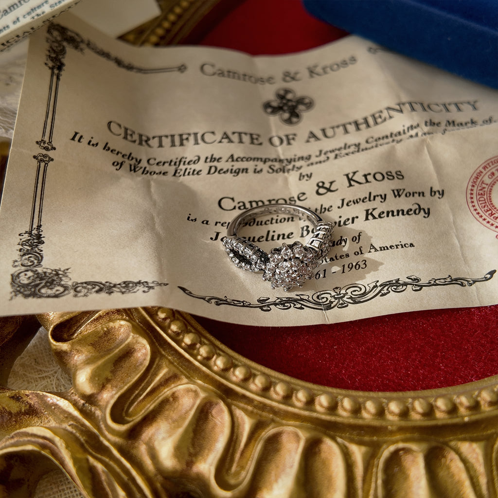 Detailed image of the ring placed on the certificate of authenticity, including a magnified top-down view of the ring design.