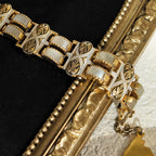 A close-up of the gold damask bracelet reveals the texture of the mother-of-pearl.