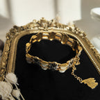 The gold damascus bracelet is in a circular shape, showcasing the bracelet's full appearance.