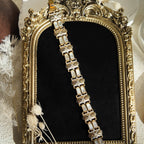 The gold Damask bracelet was stretched out to show what it looks like when not being worn.