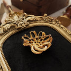 The back of the HOLLYCRAFT brooch is crafted from gold-plated metal, its surface gleaming and flawless with age, showcasing high-quality workmanship.