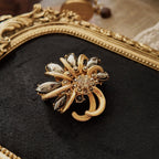 This high-quality grey rhinestone brooch features a uniquely colored rhinestone, making it a perfect addition to any vintage collector's collection.