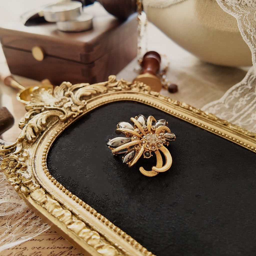 Fine jewelry, a unique design, a true one-of-a-kind piece. A crystal-encrusted brooch.