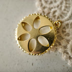 Vintage gold warrior pendant with an open back and retro shoulder strap, a symbol of courage.