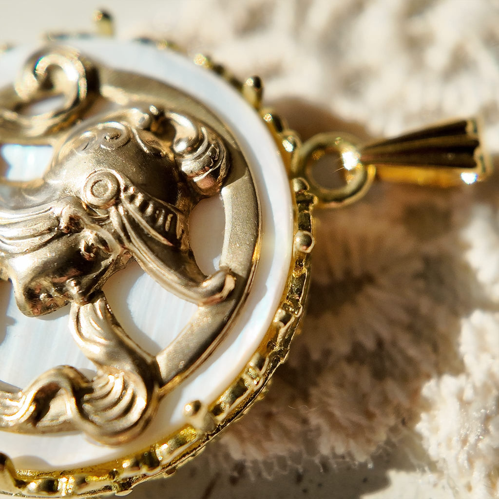 Golden lucky charm, composed of vintage accessories, brass figurative design, mother-of-pearl base.