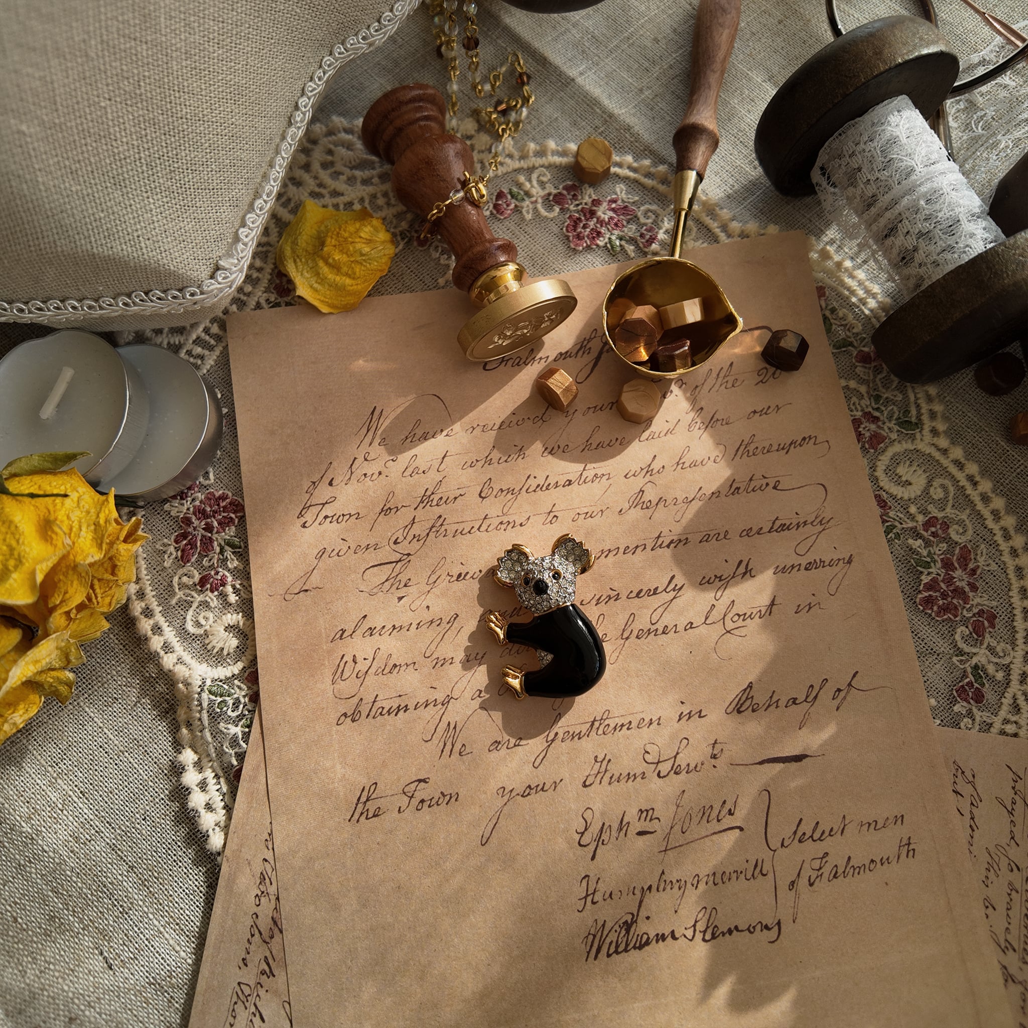 This koala brooch from D'orlan lies in the sunlight, showcasing its perfect condition and size.