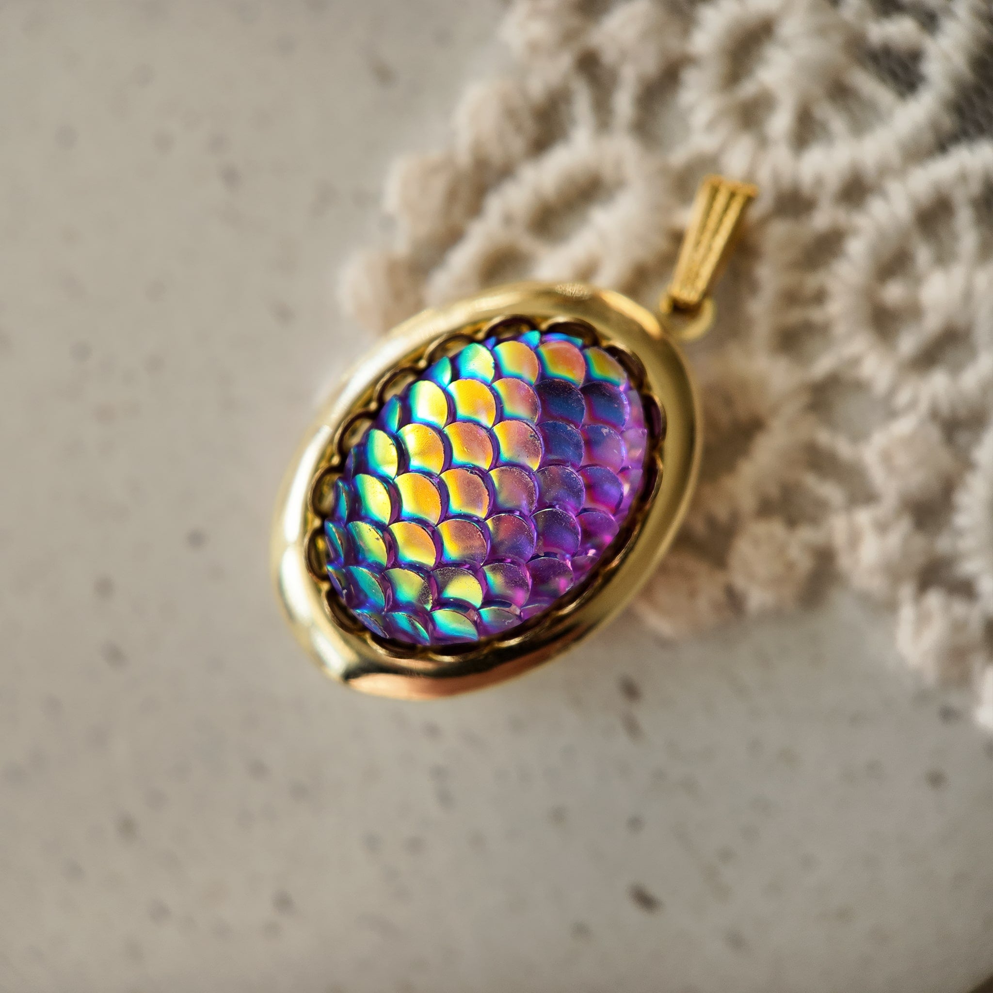 Laser-engraved fish-scale photo box pendant, oval metal outline, gold back plate. Three-dimensional sculpted West German glass jewelry, purple iridescence, fish-scale shape. Vintage ocean-themed jewelry, legend of the golden mermaid.