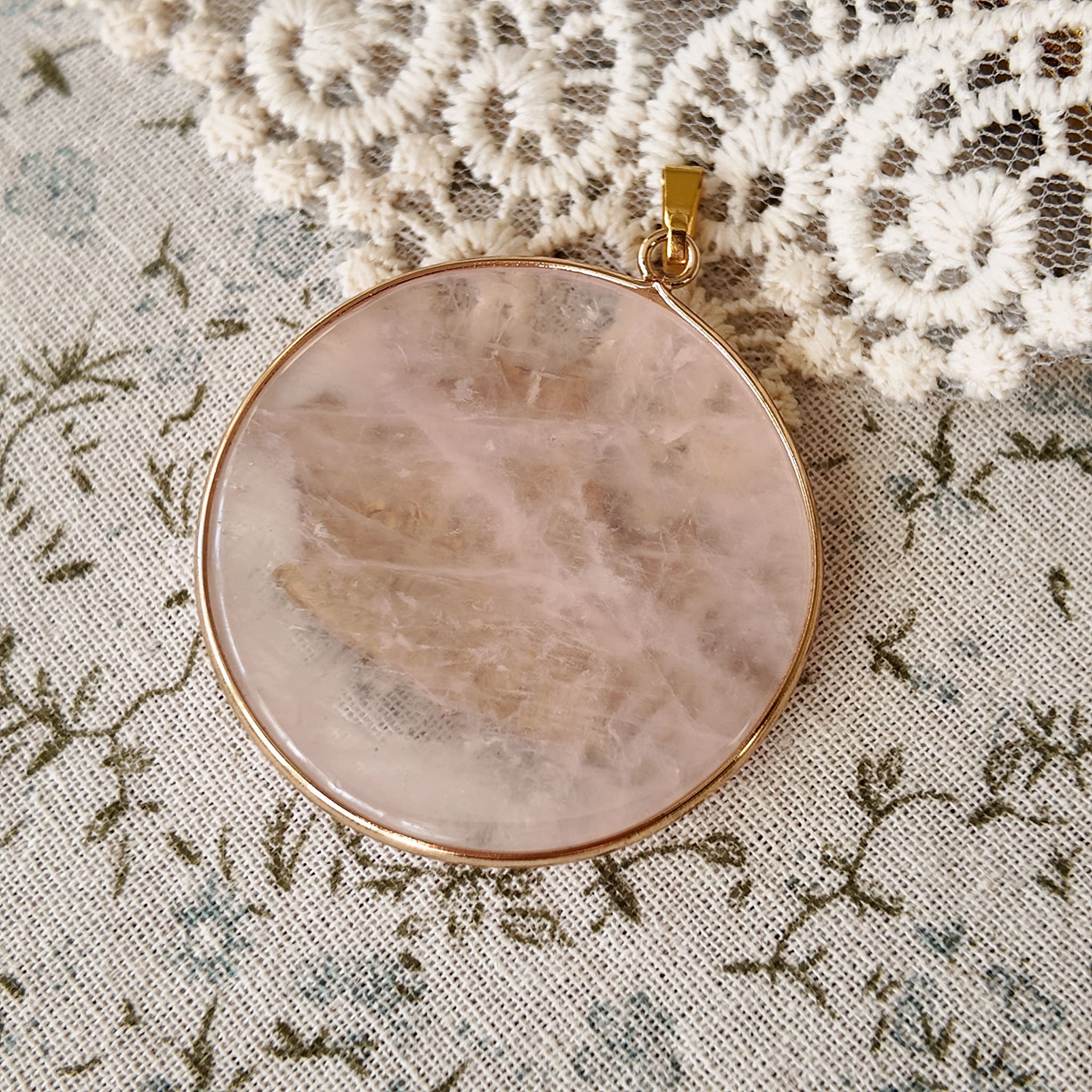 Round rose quartz pendant, a must-have for crystal lovers. Rose quartz.