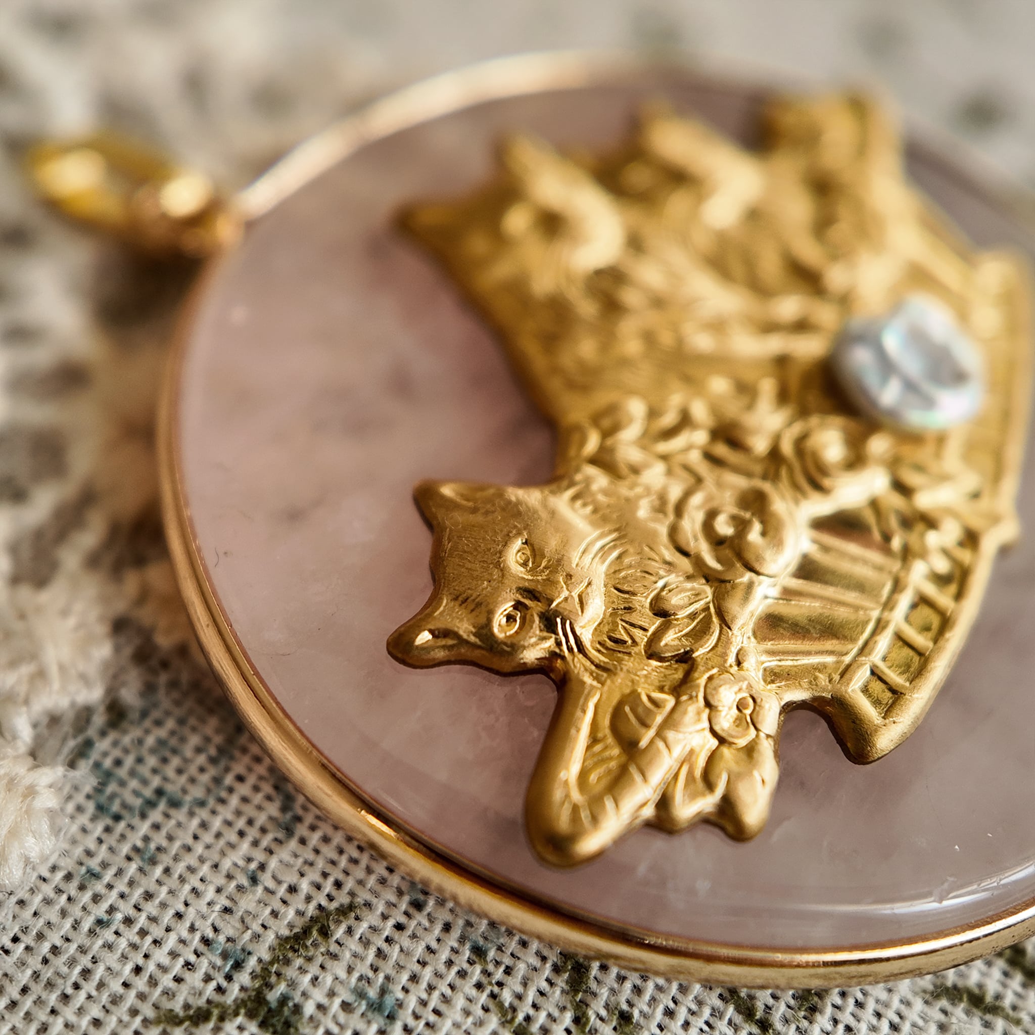 Adorable pink crystal cat jewelry, featuring a cat and crystal, cute and sparkling, with a perfect pink gold hue.