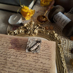 A close-up view of the back of the faux moonstone brooch, showcasing the back of this vintage brooch, including the condition of the back pin.