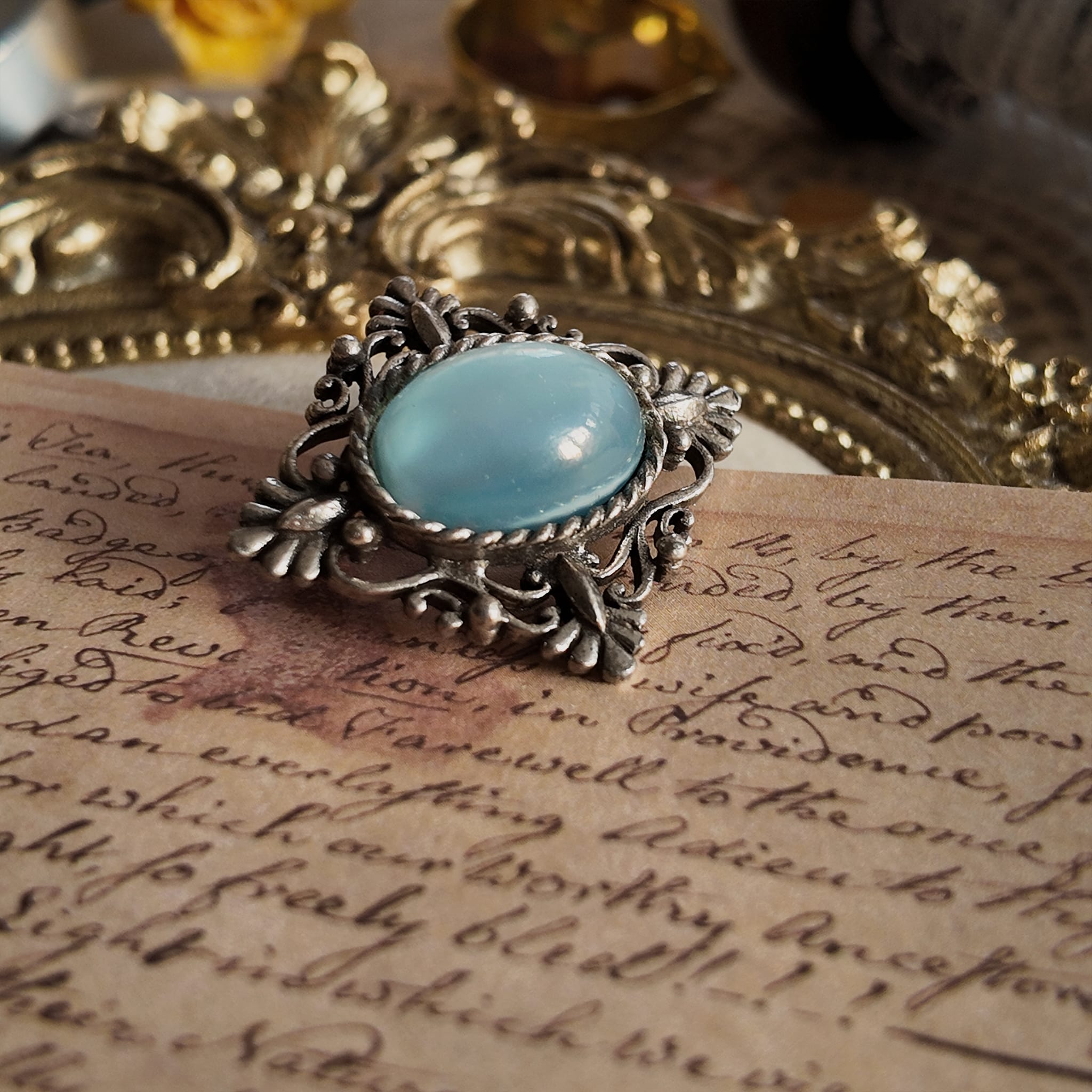 The bottom view of the imitation opal brooch shows the vintage brooch viewed from below.
