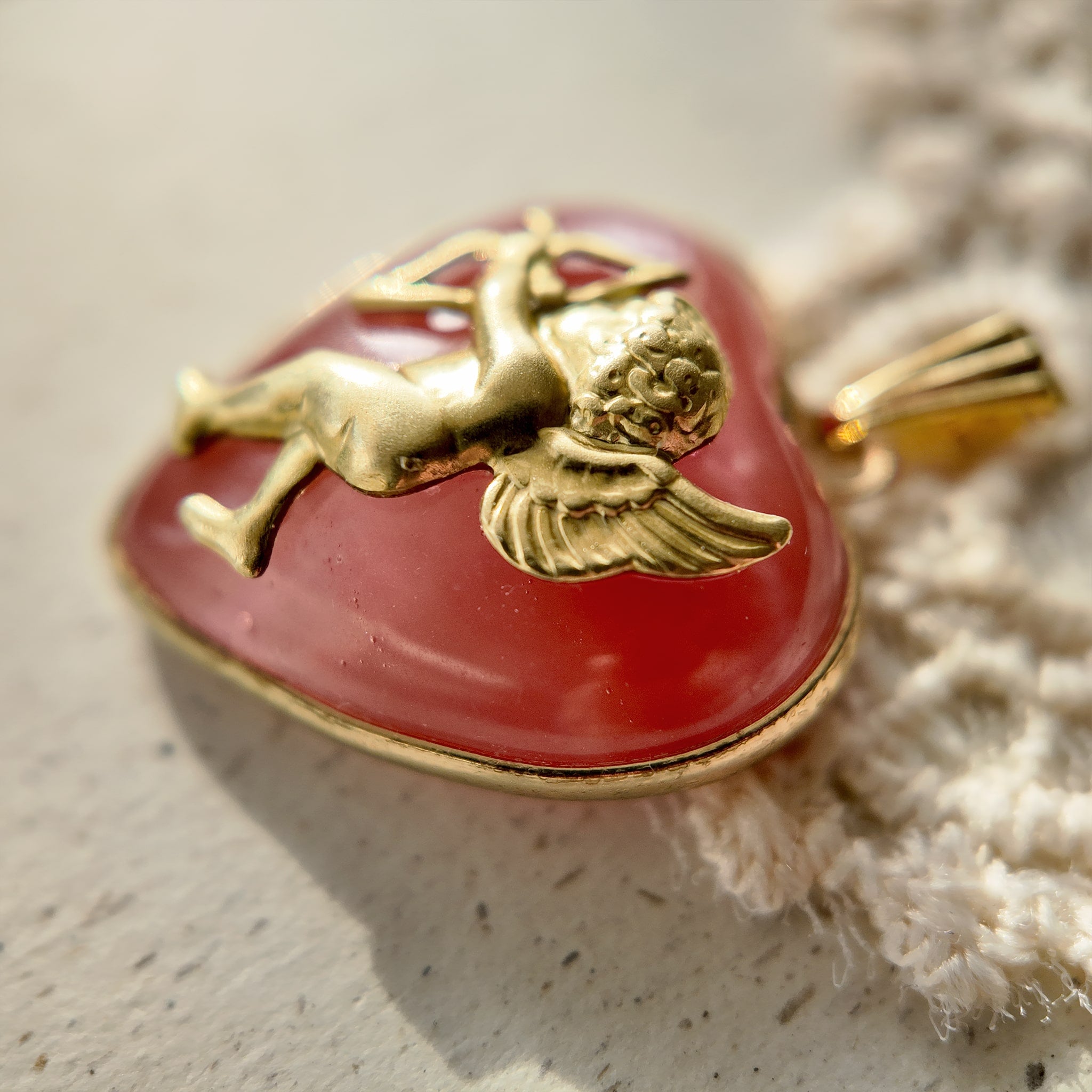 Vintage angel jewelry. Angel pendant, featuring a cute angel holding a bow and arrow.