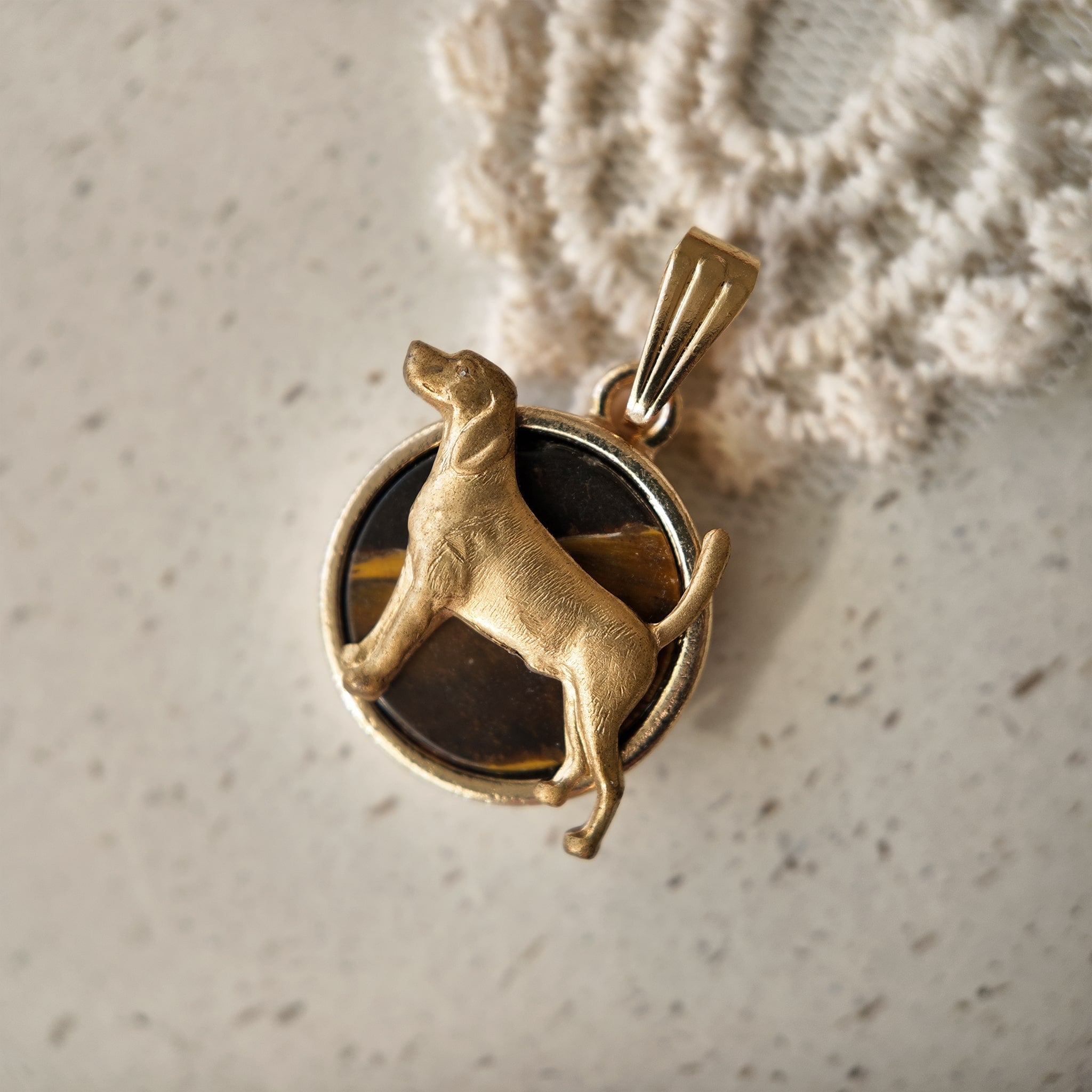Natural tiger's eye pendant, dog design, looks like a Labrador. A copper pendant featuring a dog on a round tiger's eye stone.