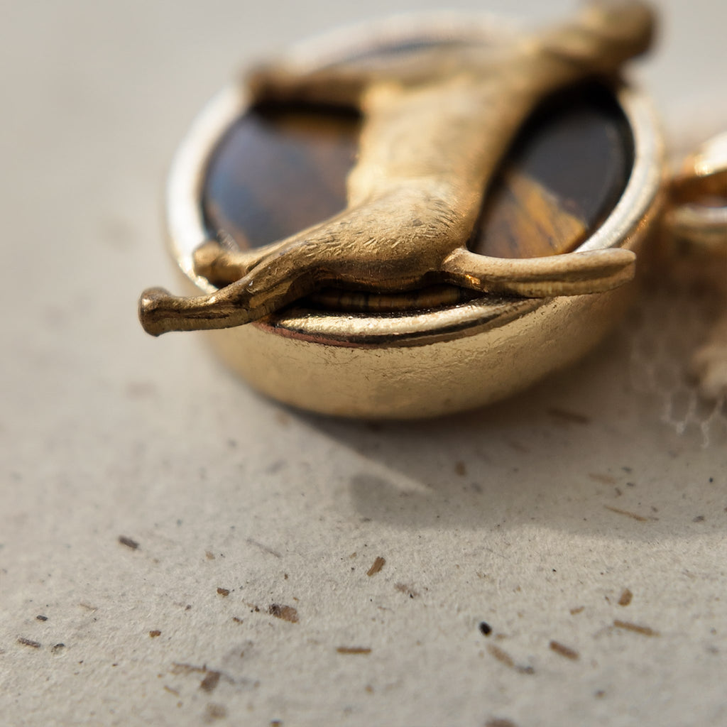 Tiger's eye metal pendant, a natural golden-brown stone pendant, featuring a dog design. A talisman for dog lovers.
