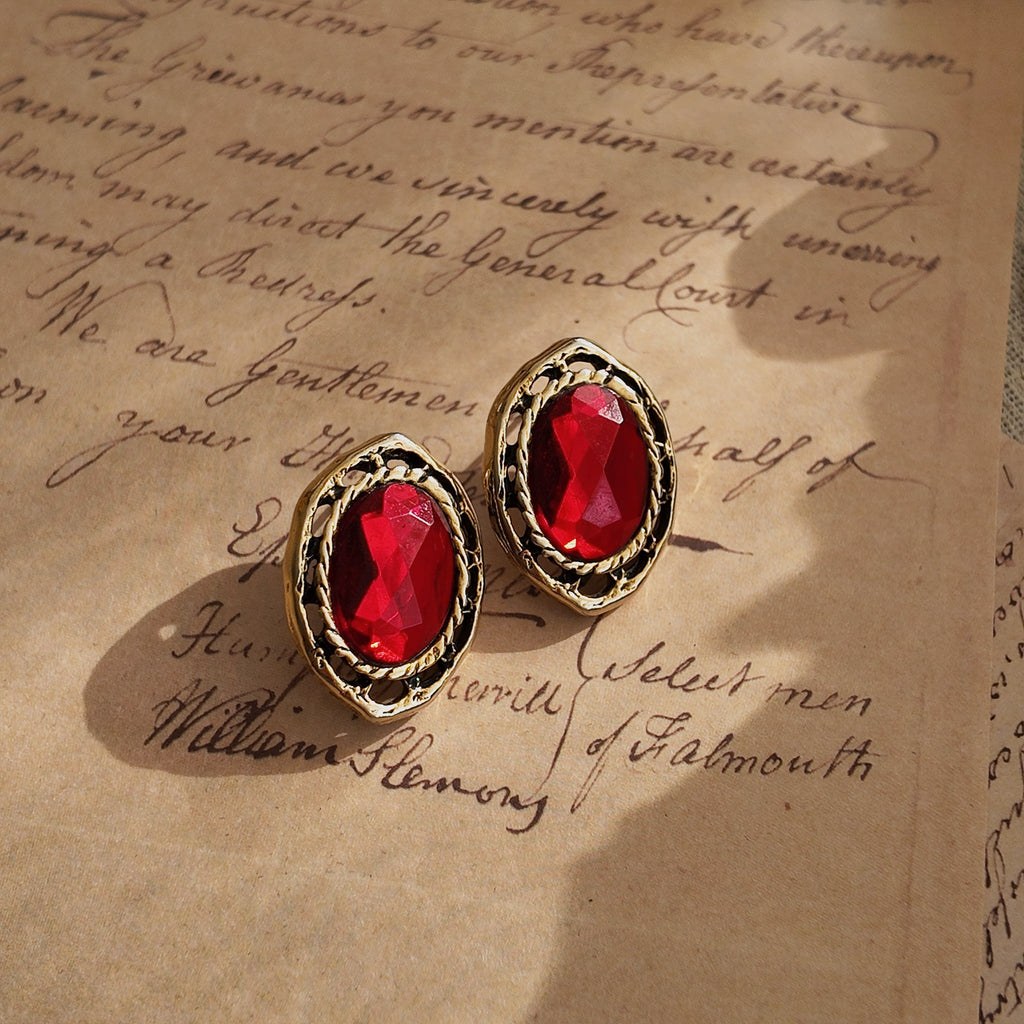 Vintage-style jewelry, ruby ​​stud earrings, Art Nouveau style. Antique design, polarized gemstones.