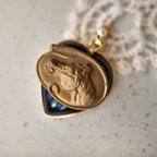 This black heart-shaped glass pendant features a horse motif, with the horse's profile gazing into the distance. Animal-themed jewelry from a vintage era, it's a must-have for horse-themed jewelry collectors.