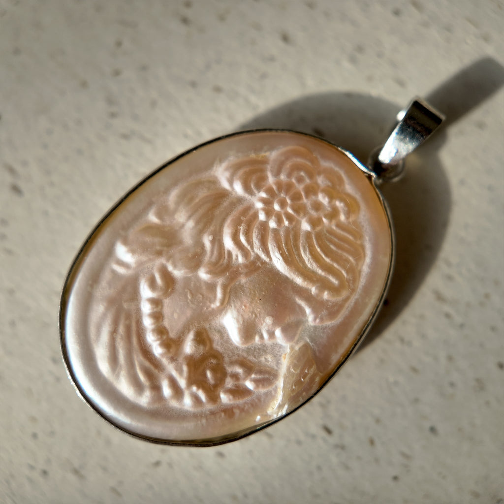 Mother-of-pearl carved Cameo figure pendant. Pearl carved jewelry, profile of a young girl, Cameo figure.
