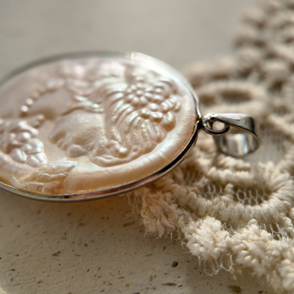 Vintage Cameo jewelry, featuring a young girl's profile, hand-carved, and made of pearls.