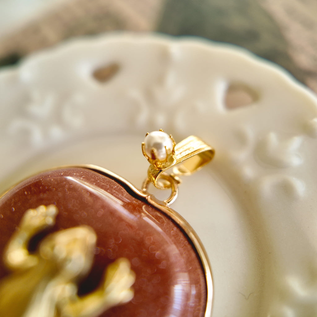 The Character Arc branded packaging, presenting the Sparkle Frog pendant as a meaningful gift for ambition and joy.