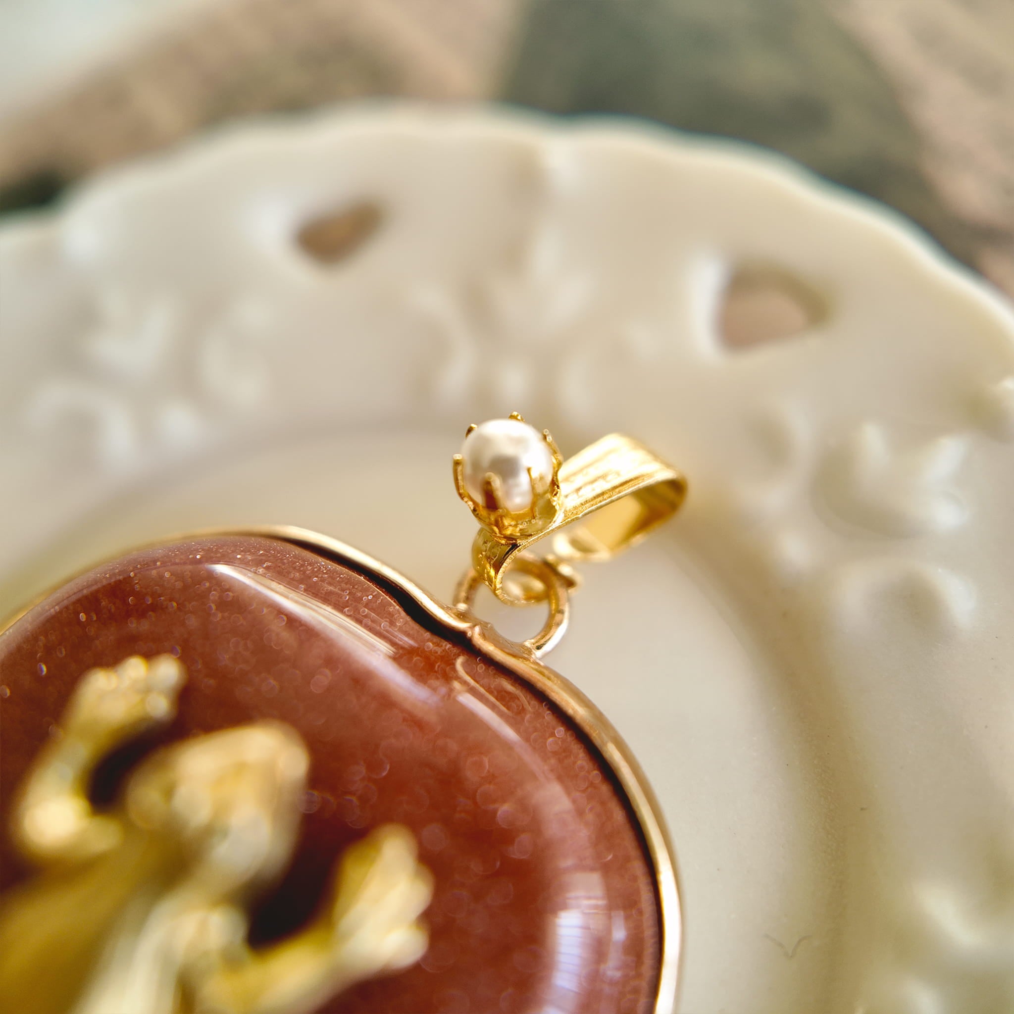 The Character Arc branded packaging, presenting the Sparkle Frog pendant as a meaningful gift for ambition and joy.