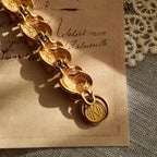 A macro shot honestly showing the significant and visible plate loss at the connection points between the bracelet links, sold as-is for its authentic character.