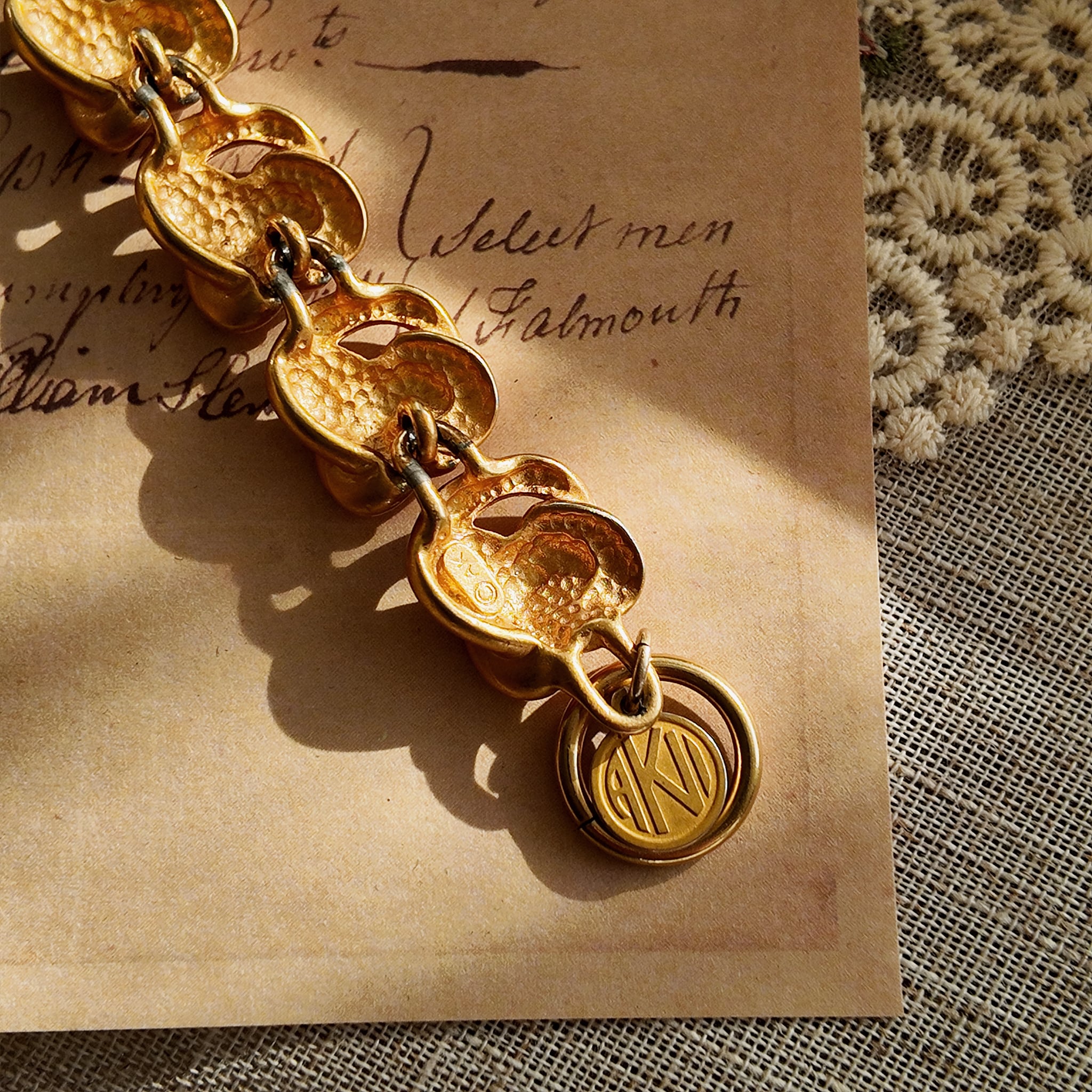 A macro shot honestly showing the significant and visible plate loss at the connection points between the bracelet links, sold as-is for its authentic character.