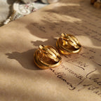 A detailed photo of the back of the Anne Klein earrings, clearly showing a localized area of gold loss, a testament to its "well-loved" history.