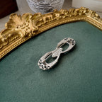 The reverse side of the antique Gothic brooch, showing its simple C-clasp construction typical of the 1930s-1940s era.