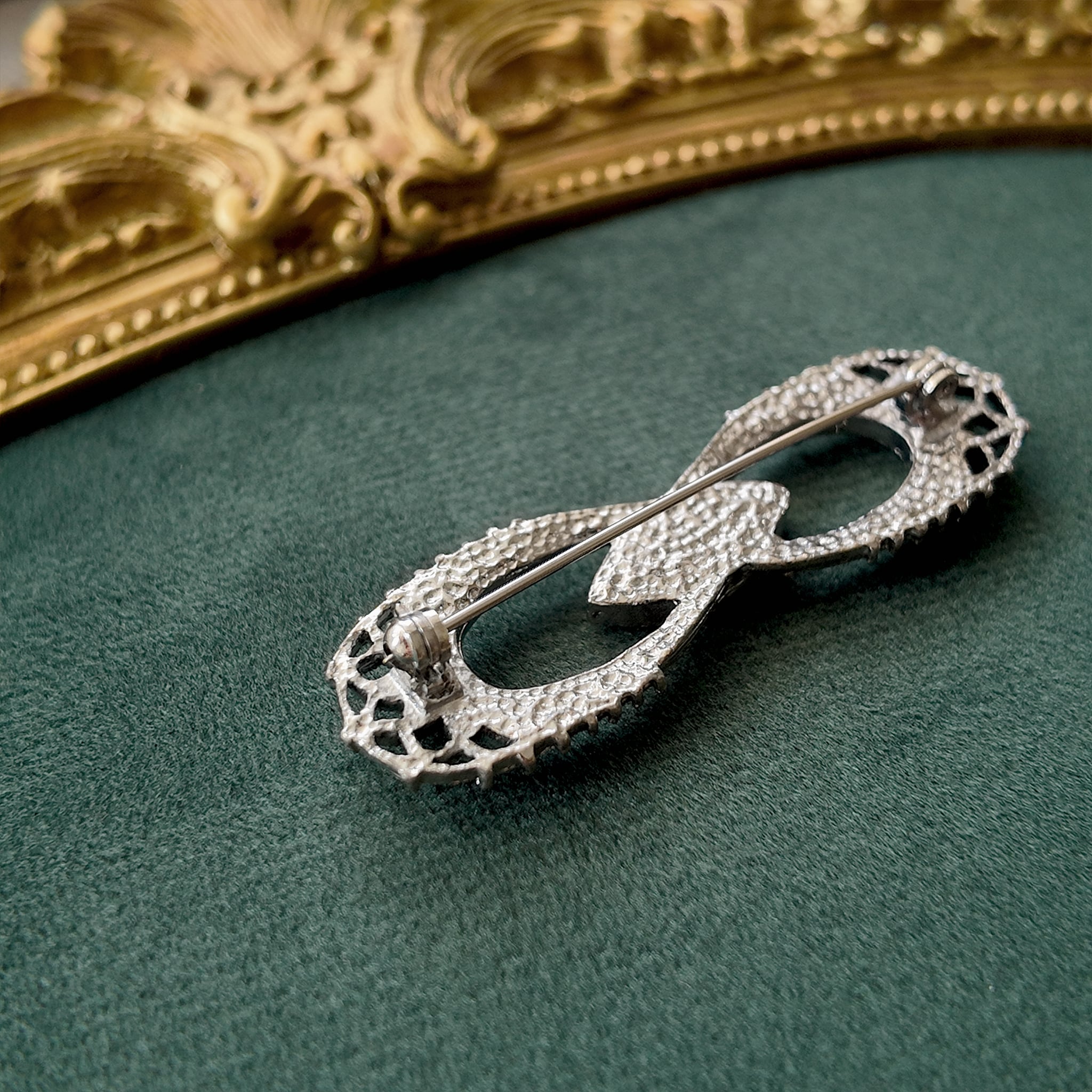 The reverse side of the antique Gothic brooch, showing its simple C-clasp construction typical of the 1930s-1940s era.