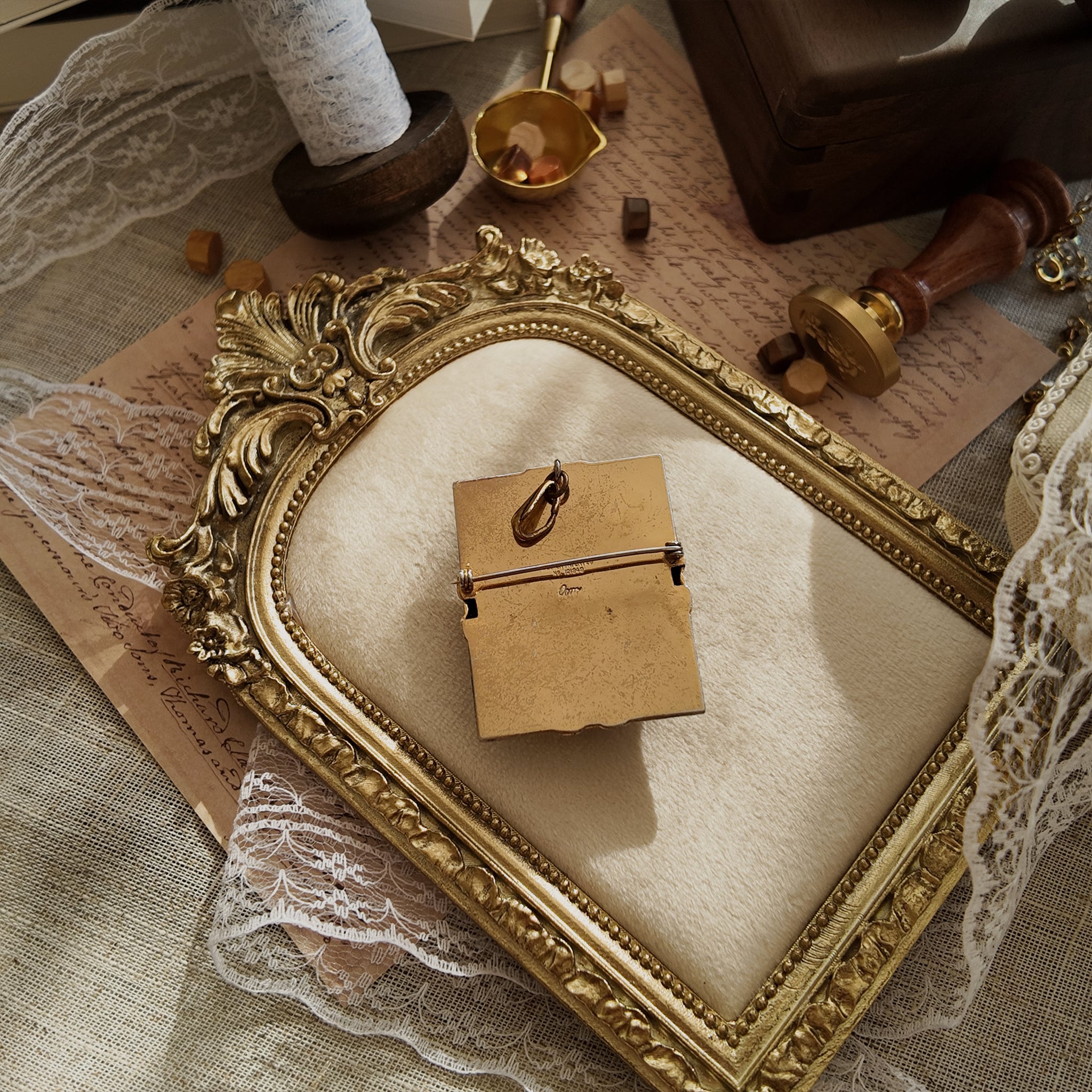 The heavily worn back of the antique brooch, showing numerous scratches and a deep patina, a testament to its long and cherished life, sold as-is.