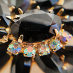 A macro shot detailing the incredible, rainbow-like fire of the Aurora Borealis rhinestones, a signature of high-quality 1960s costume jewelry.