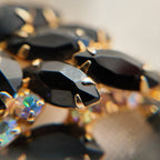A macro shot detailing the incredible, rainbow-like fire of the Aurora Borealis rhinestones, a signature of high-quality 1960s costume jewelry.