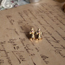The Avon bell earrings shown with both the heavily worn, original backs and a brand new pair of replacement backs, which are included for your comfort.