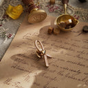 The "Hopeful Supporter" brooch styled next to a thank you card to emphasize its identity as a piece of solidarity and a meaningful gift of gentle strength.