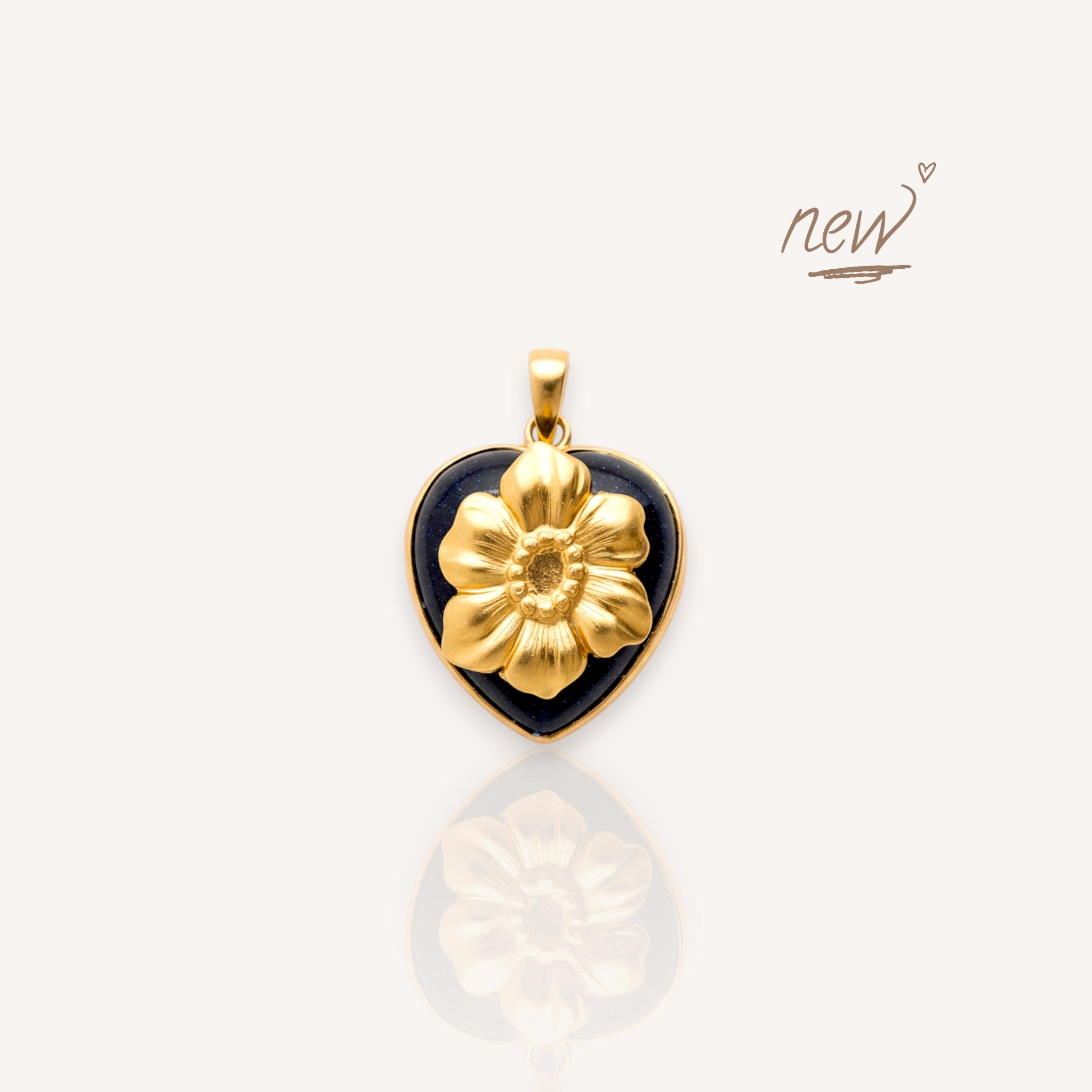 Front view of The Bloom in the Dark pendant featuring a sparkling midnight blue sandstone heart with a large brass poppy.