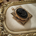 A detailed photo honestly showing the significant fading and loss of the gold plating on the front frame of the Coro cameo, defining its "Wabi-Sabi" condition.
