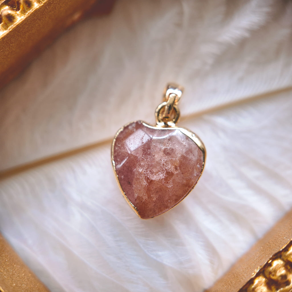 The reverse side of the upcycled Strawberry Quartz charm, showcasing the clean bezel setting and the beautiful, natural red inclusions visible through the stone.
