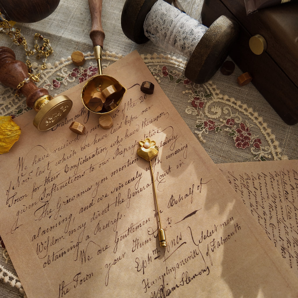 "The Secret Magician," a dainty heart-shaped brooch in a soft, matte gold finish, crowned with a single, lustrous faux pearl. A perfect Light Academia accessory.