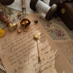 "The Secret Magician," a dainty heart-shaped brooch in a soft, matte gold finish, crowned with a single, lustrous faux pearl. A perfect Light Academia accessory.