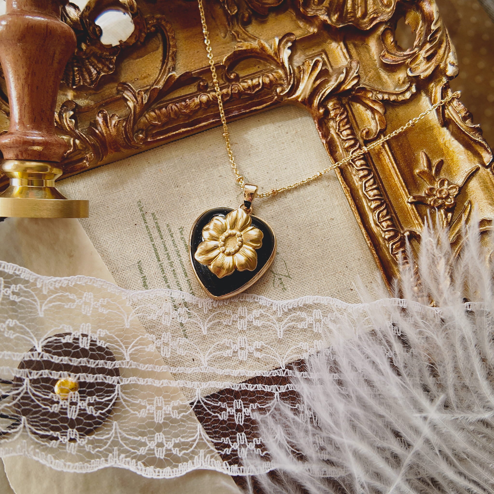 Moody flatlay photography of the galaxy stone necklace surrounded by vintage elements and dark aesthetic props.